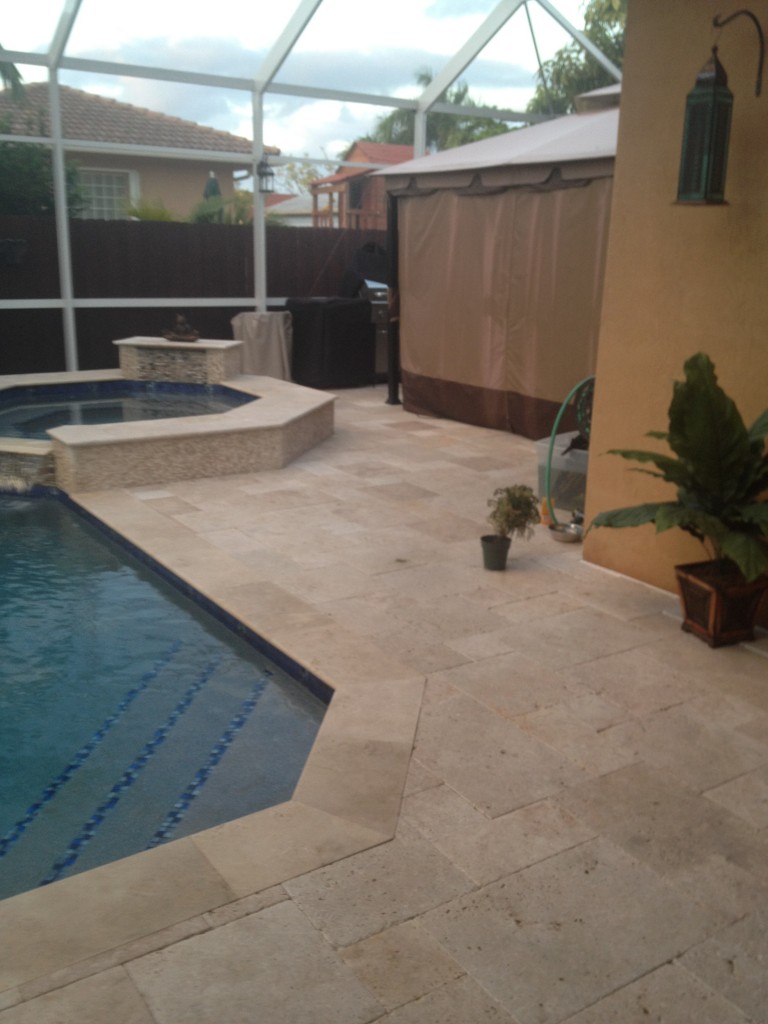 Tumbled travertine pavers around pool