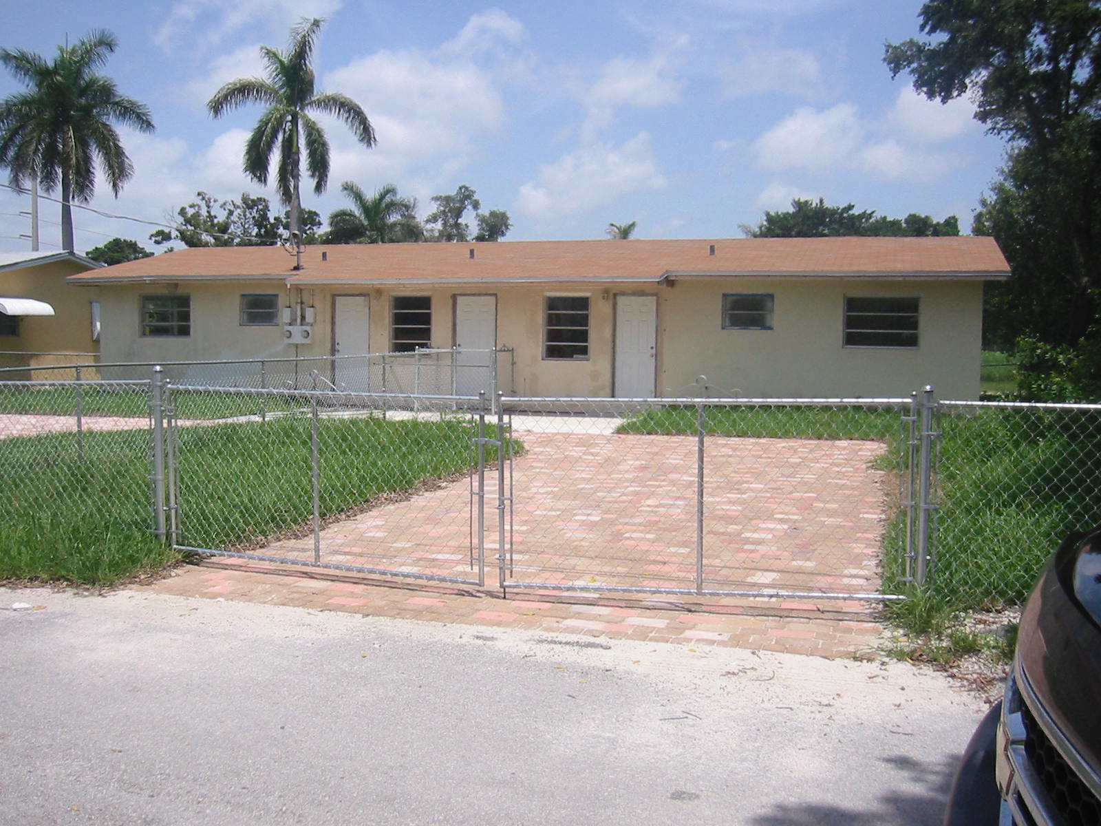 Remodeled duplex with colorful paver driveway