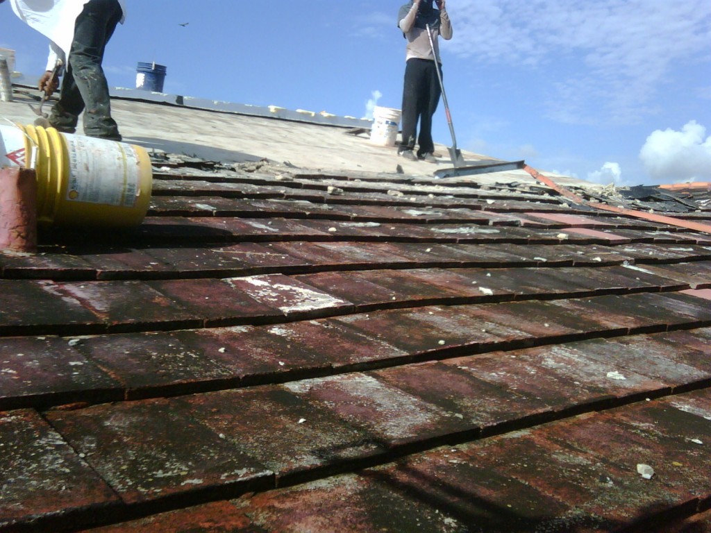 Old roof with old roof tiles being removed