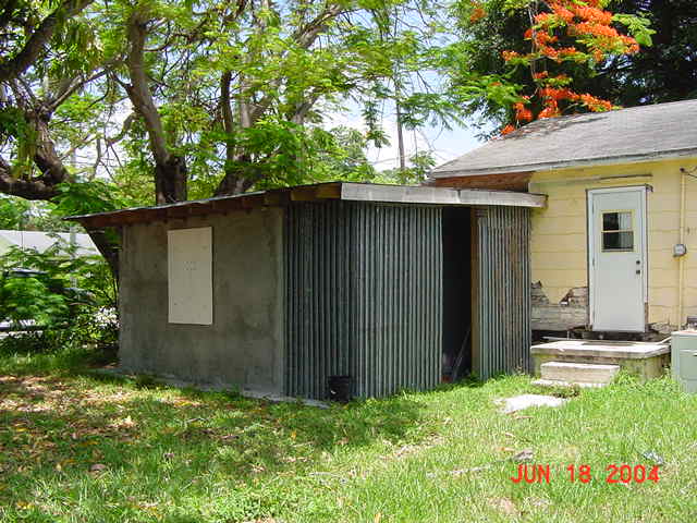 Rear of home with violations before rehabilitation