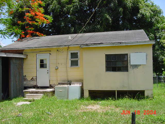 Rear of home with violations before rehabilitation