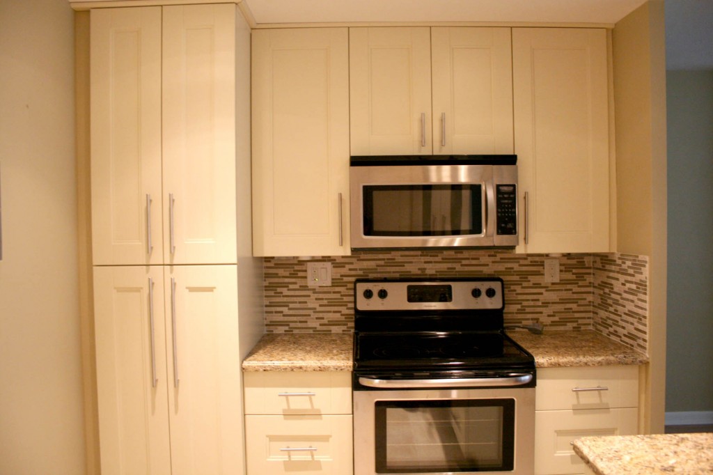 Finalized kitchen with new cabinets, microwave and oven