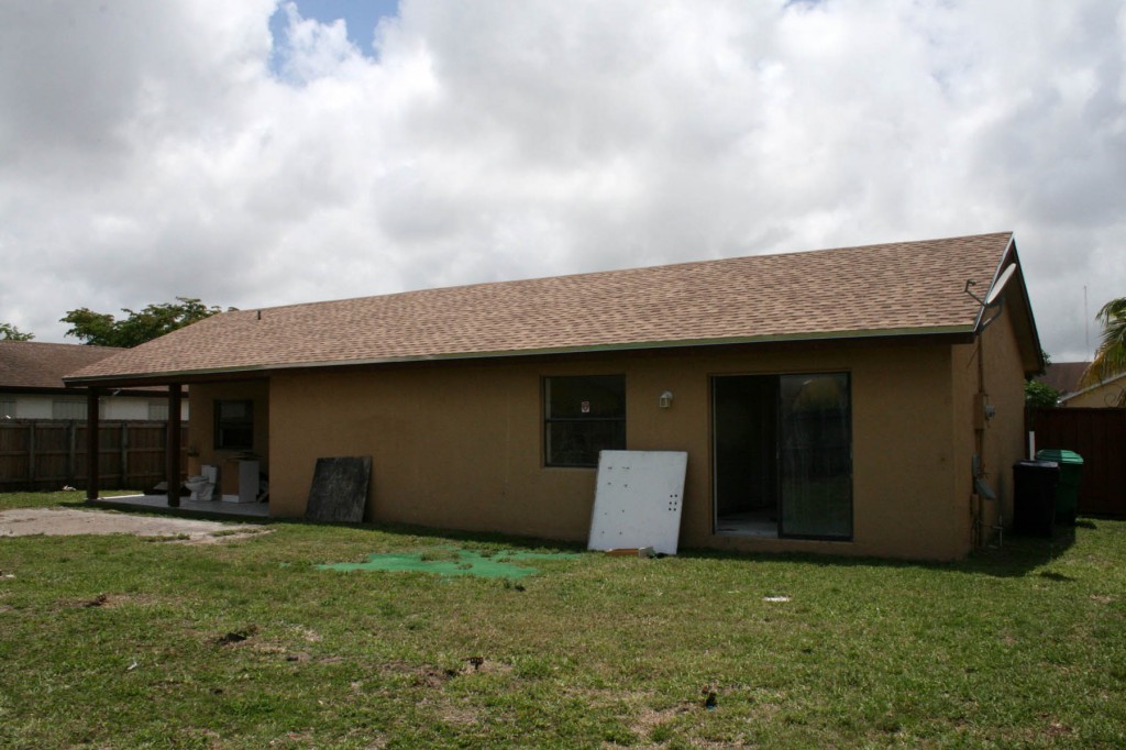 After photo of new roof shingles installed from rear of home