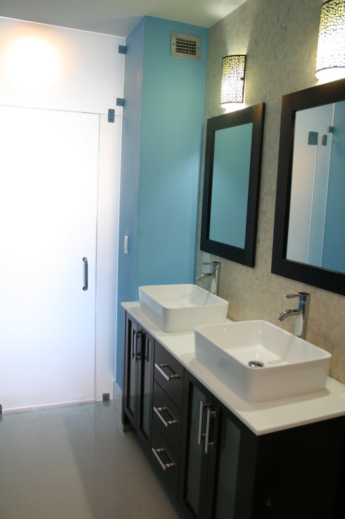 Bathroom remodel with mosaic tile on walls and frosted glass entry door