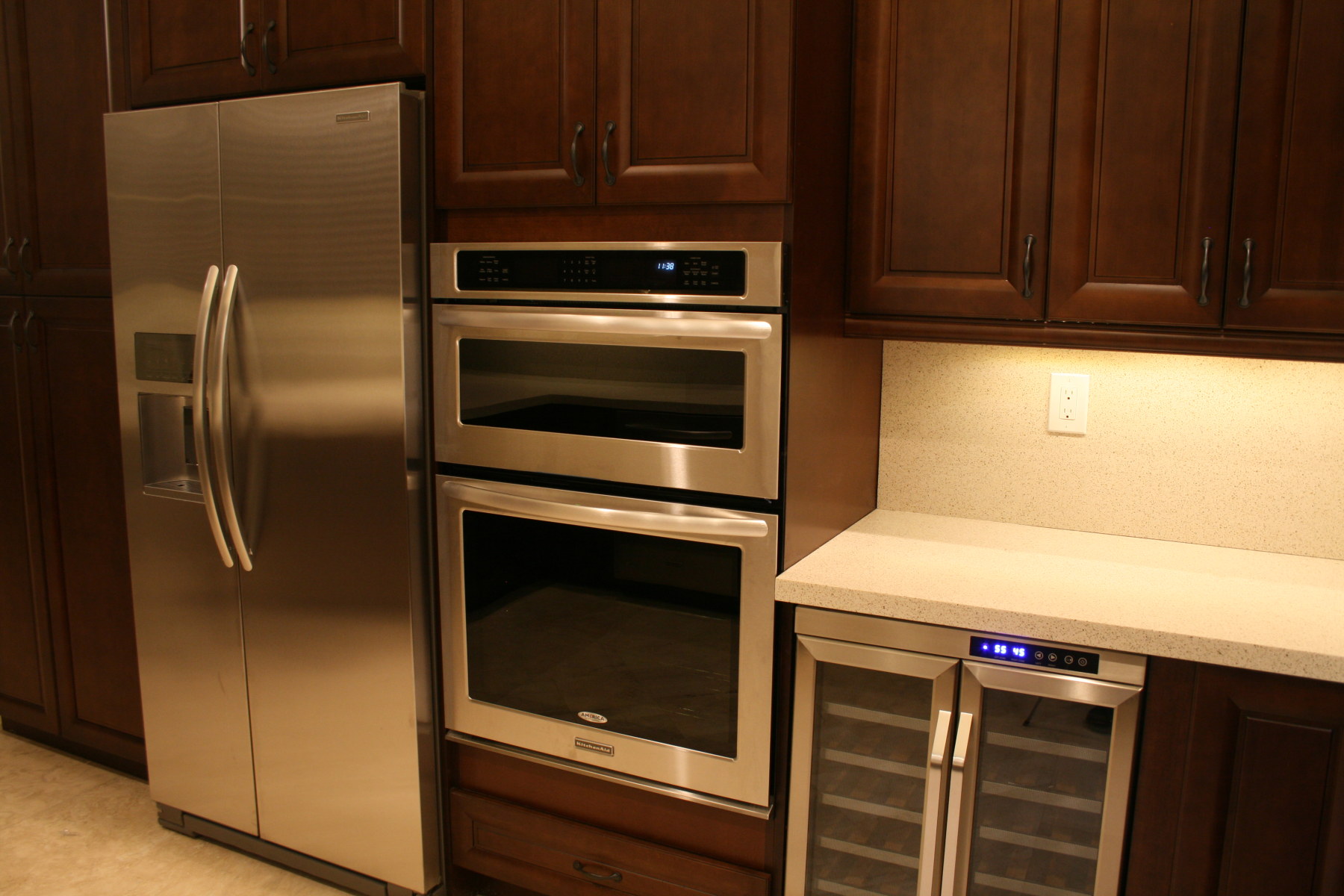 New stainless steel refrigerator, double oven and wine cooler