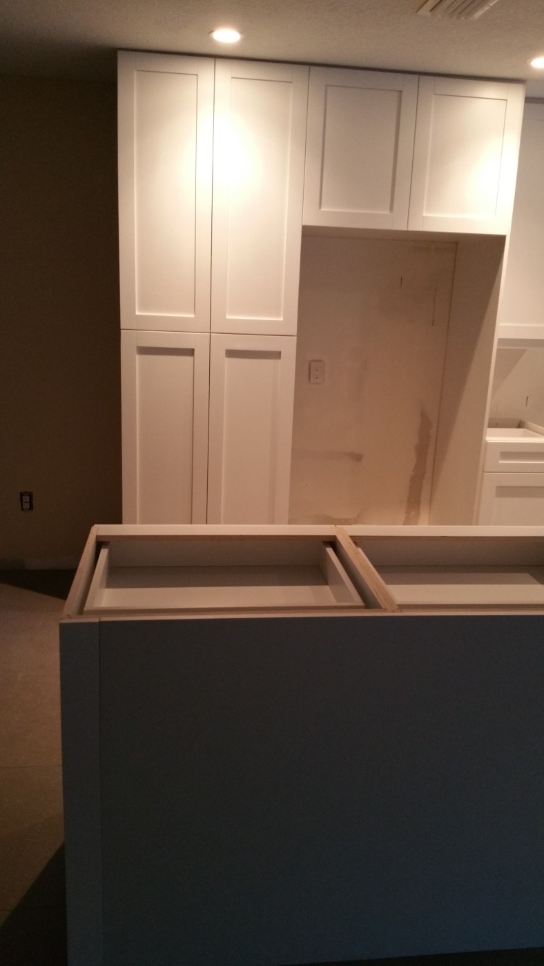During photo of removed partition and cabinet installation
