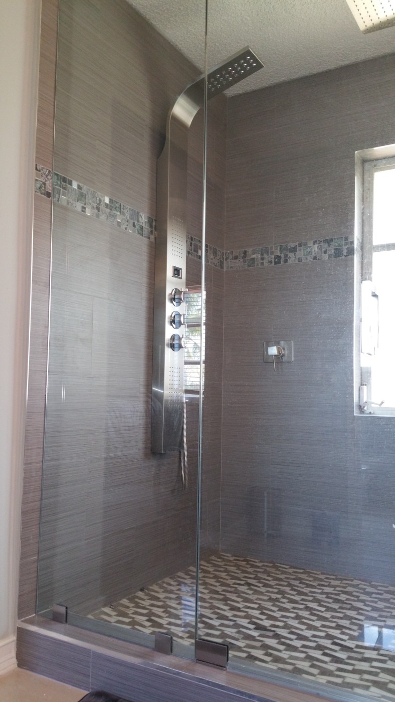 New glass shower doors and body spray shower