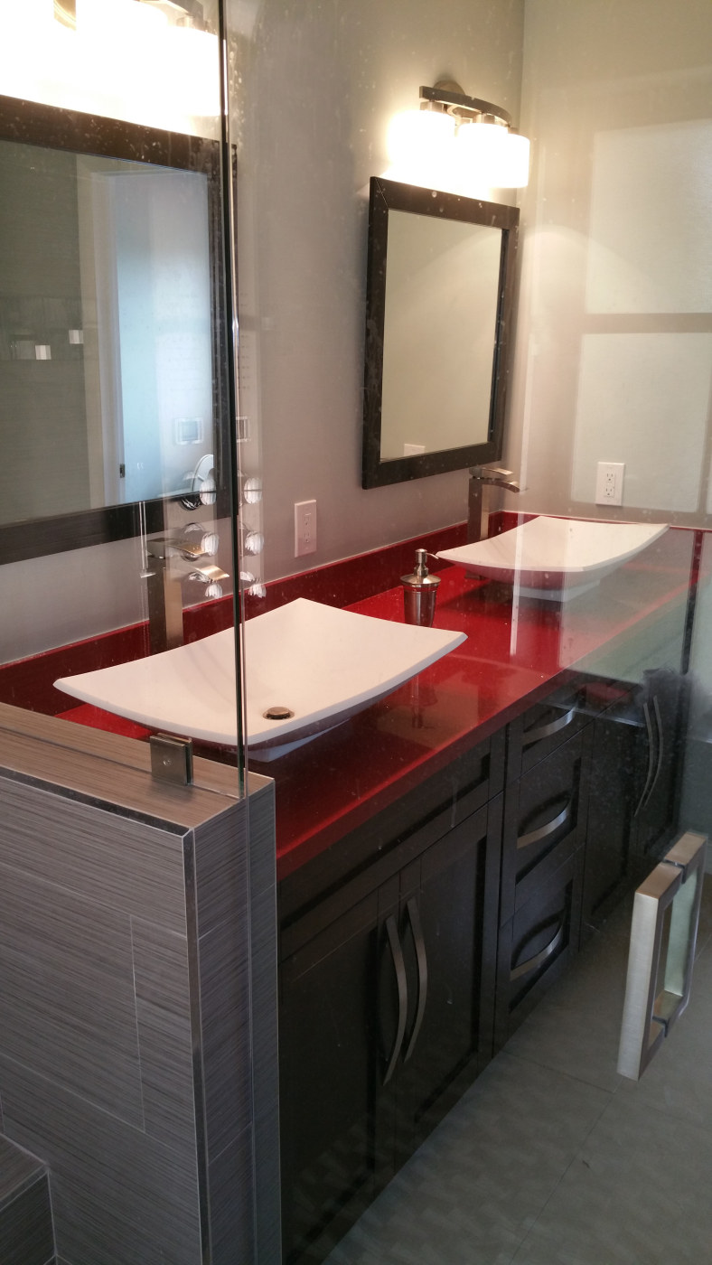 New wood vanity with red quartz counter top & vessel sinks