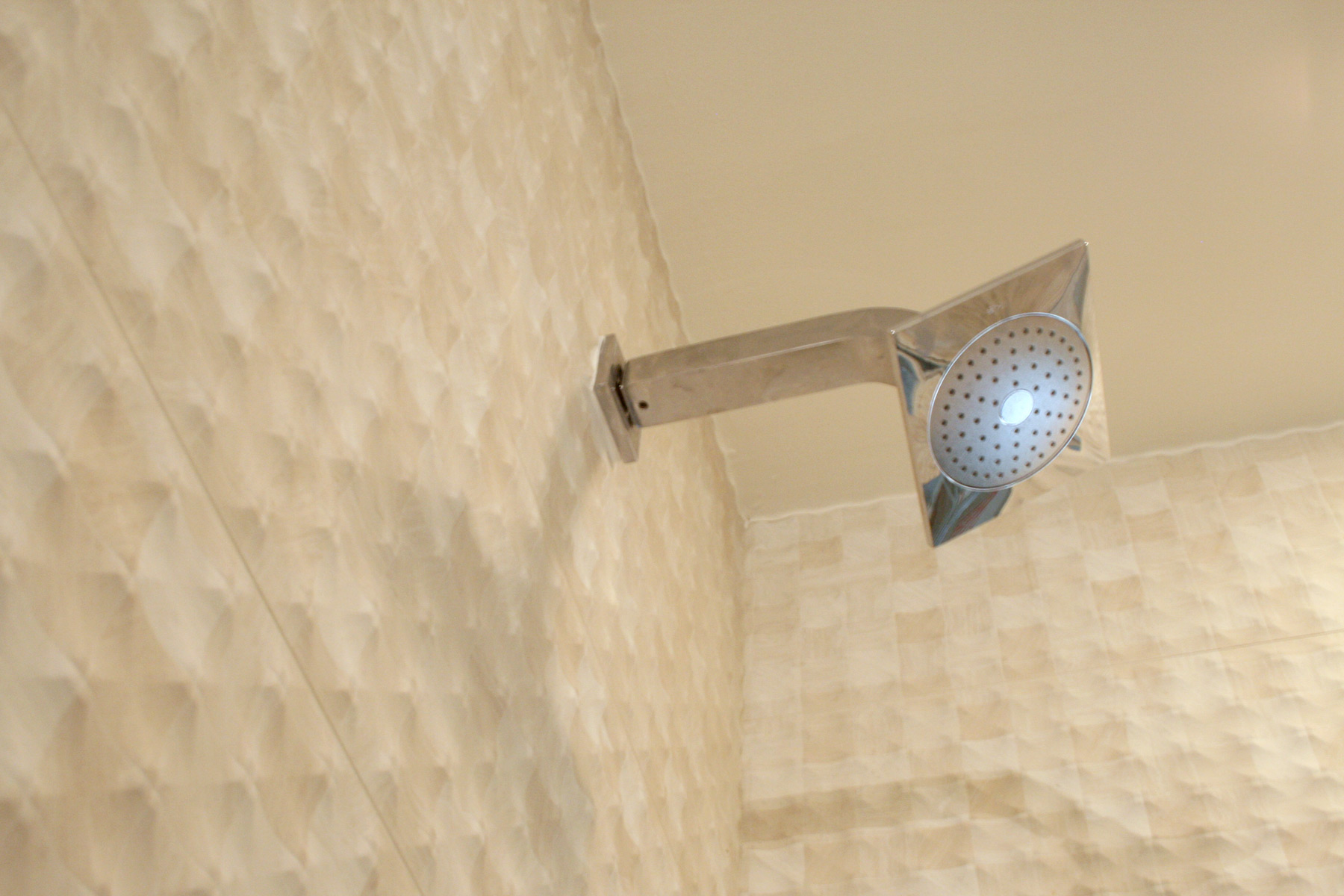 Close-up photo of porcelain wall tile & shower