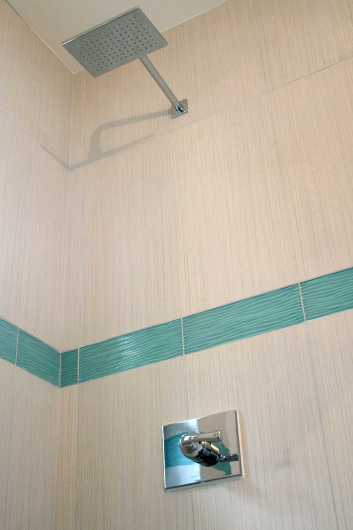 Remodeled guest bathroom shower with porcelain wall tile & new shower trim