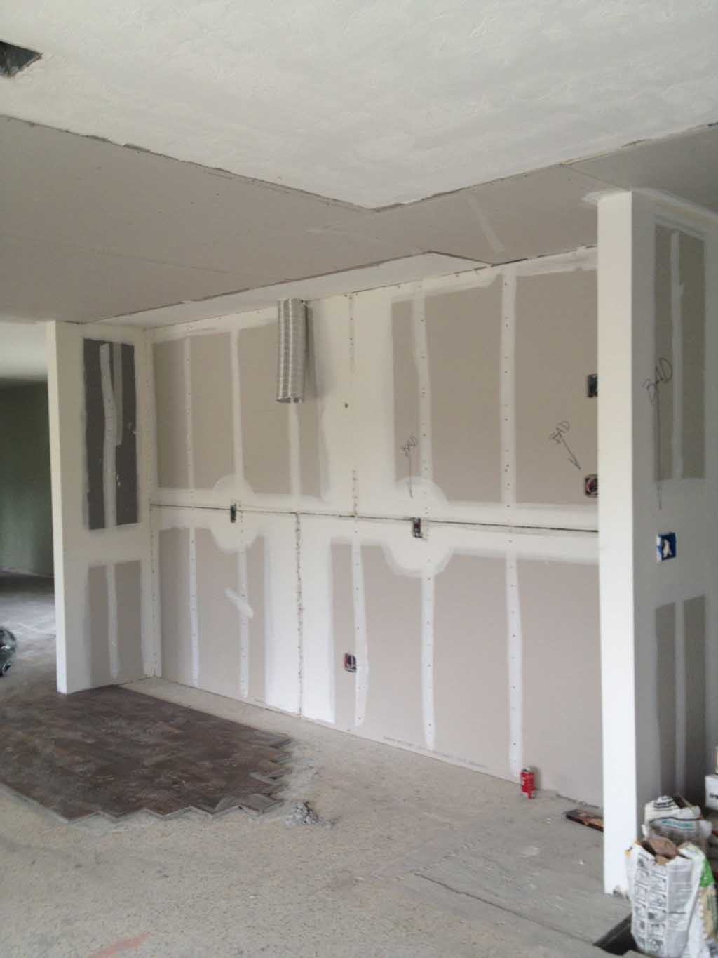 Open kitchen layout in progress with new drywall installed