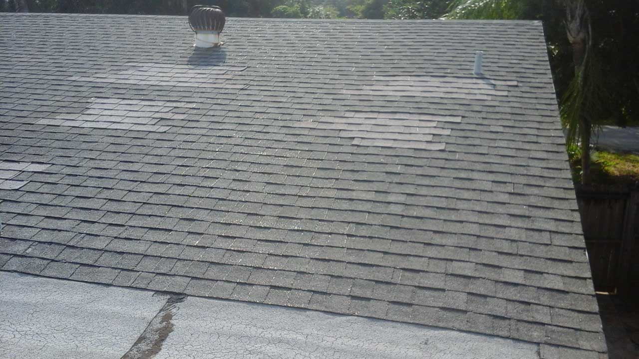 Old shingle roof with roof repair patch before removal
