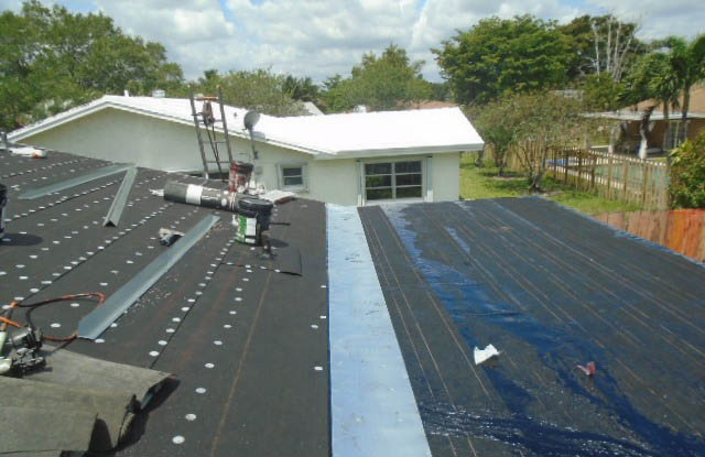 New roofing paper being installed
