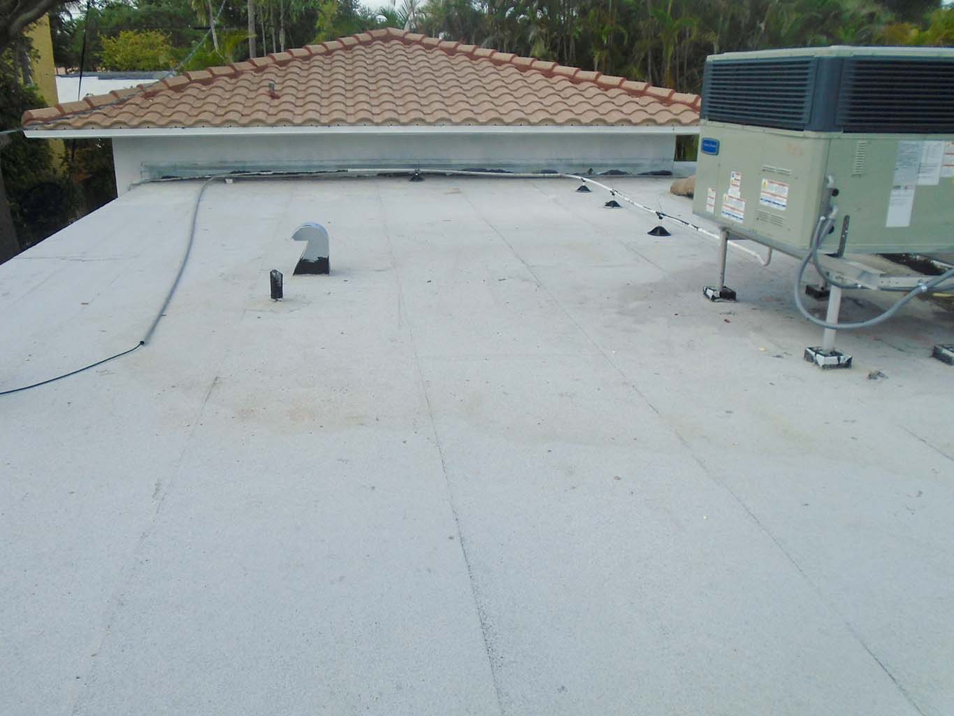 Replaced flat roof with addition tile roof in background