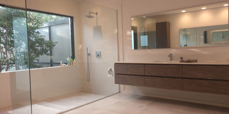 Master bath remodel with floating vanities, a large shower enclosure and freestanding bathtub