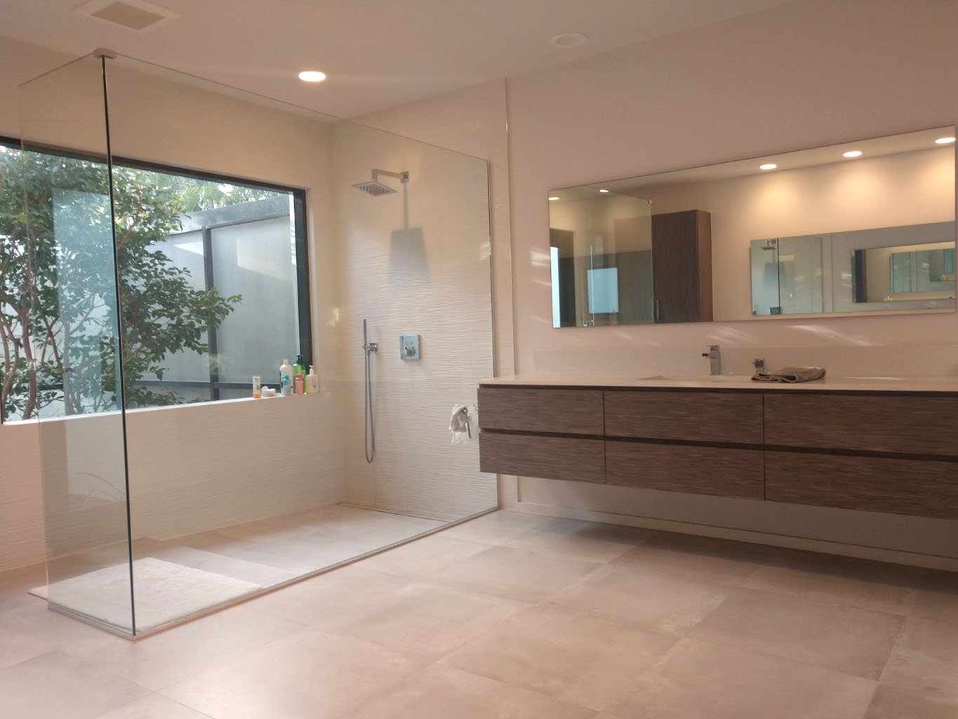 Master bath remodel with floating vanities, a large shower enclosure and freestanding bathtub