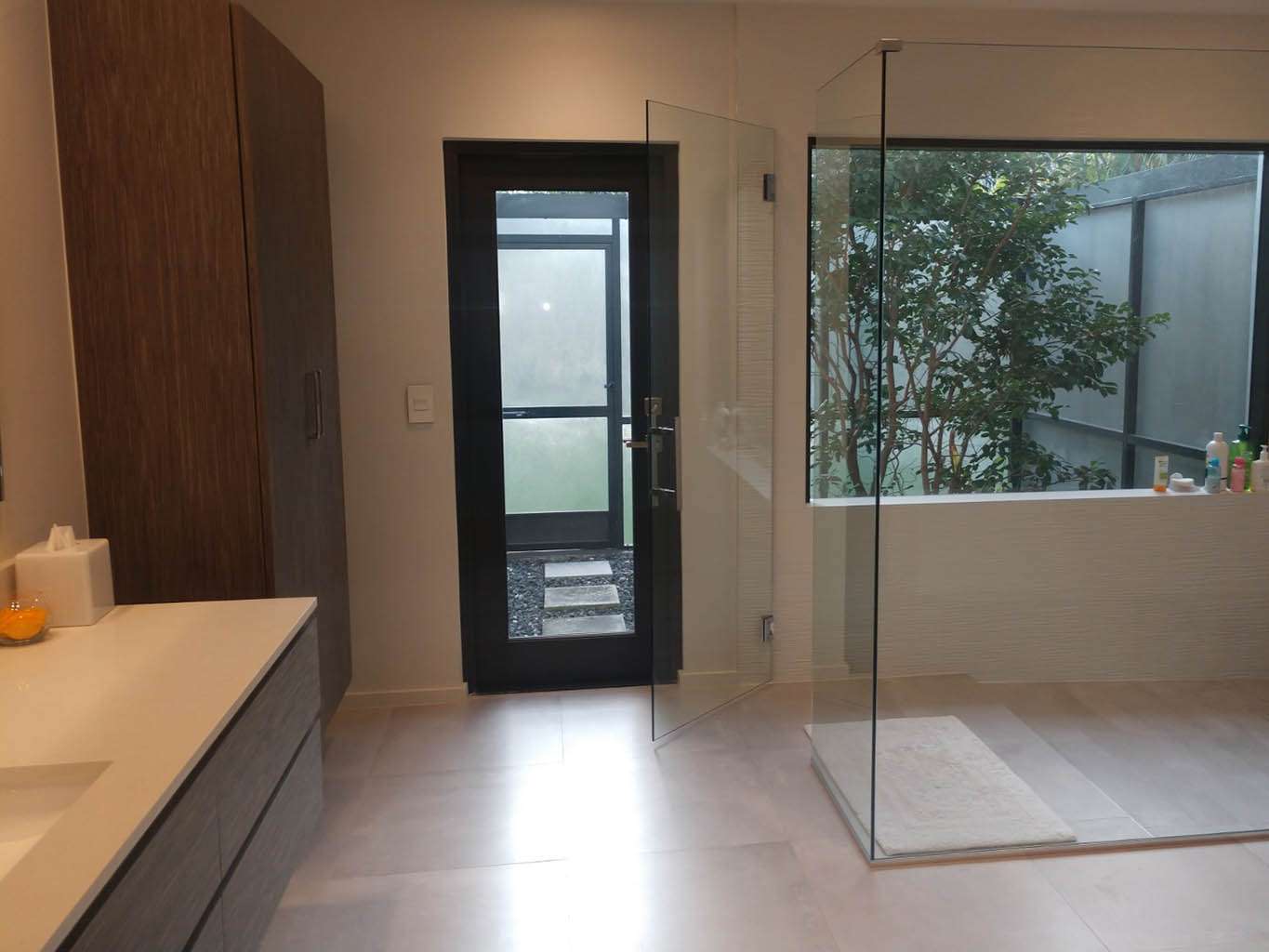 Master bath remodel with floating vanities, a large shower enclosure and freestanding bathtub