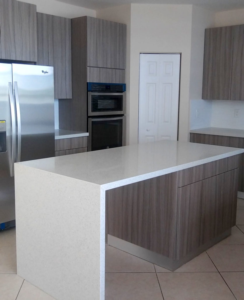 New modern kitchen with waterfall countertop at center island