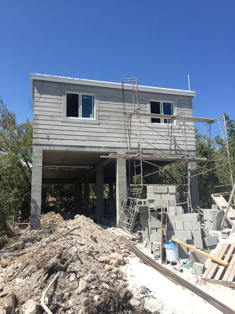 New construction with poured columns, foundation and exterior walls with stucco