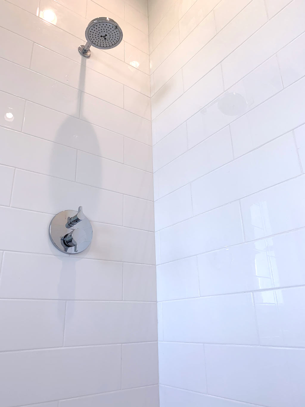Large white subway wall tiles on shower walls