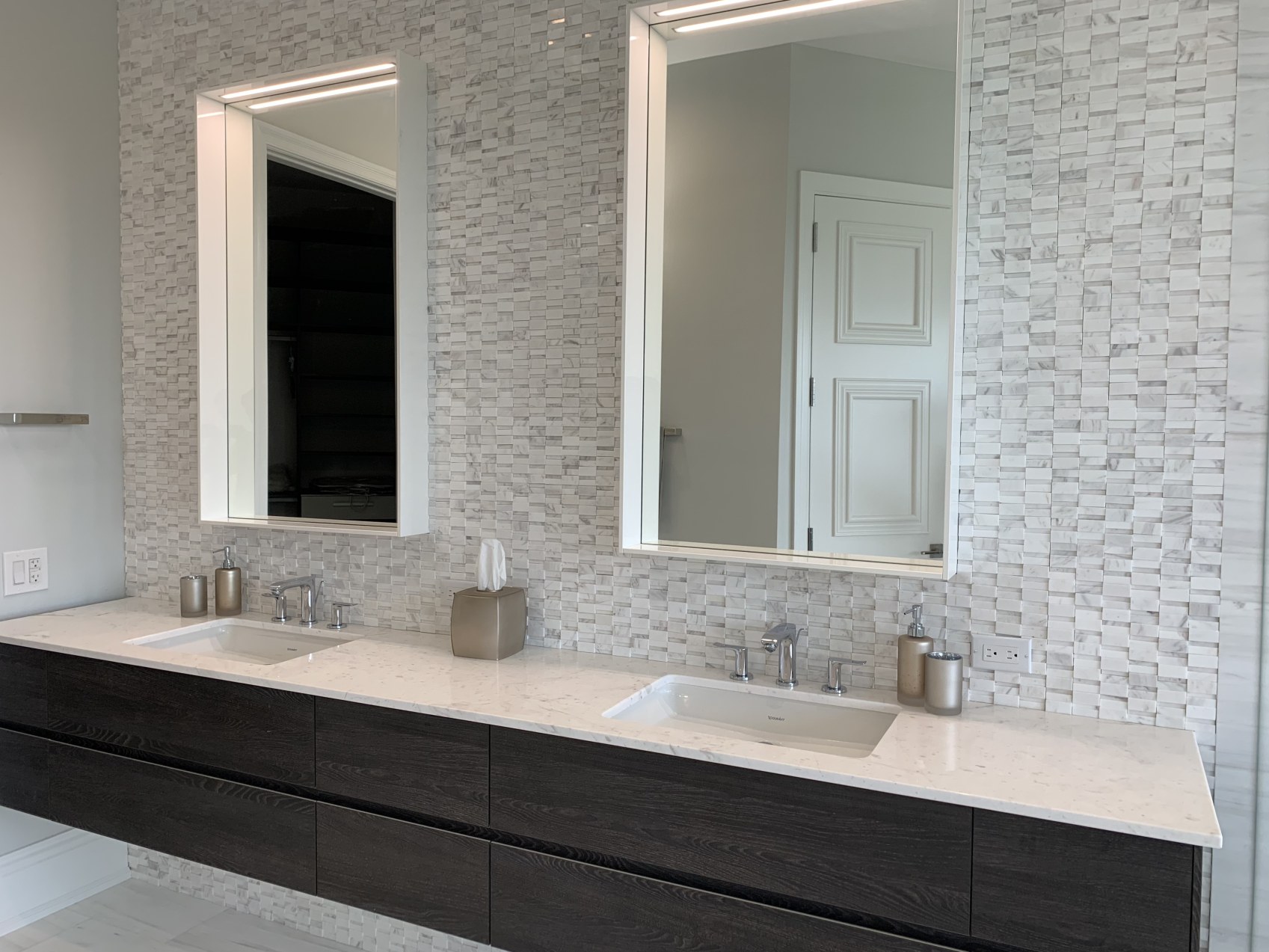 Double floating vanity with mosaic backsplash in master bathroom