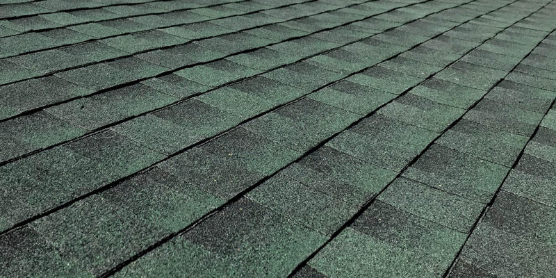 Close-up of green architectural shingles installed in Miami-Dade