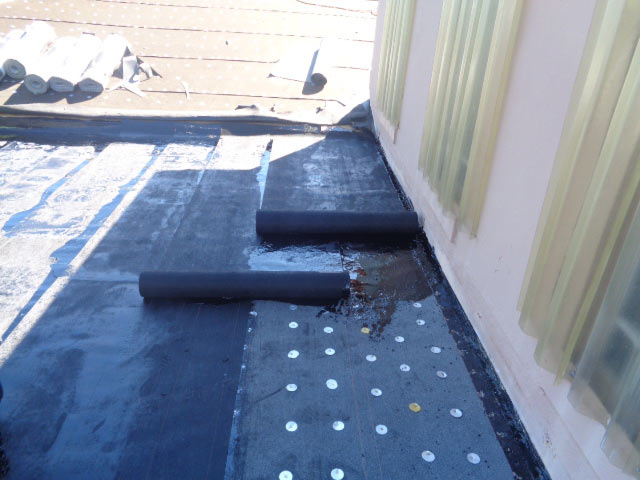 Hot mopped flat roof area over patio