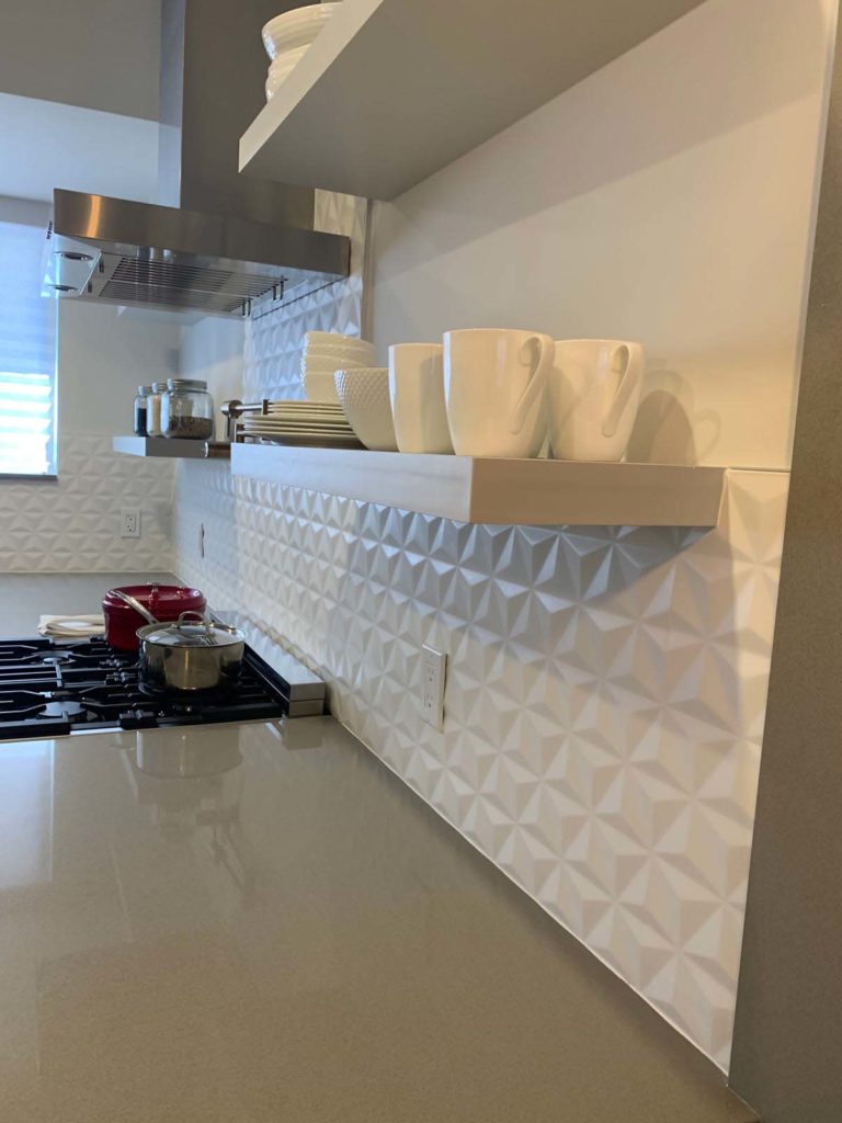Close-up of floating shelves and backsplash