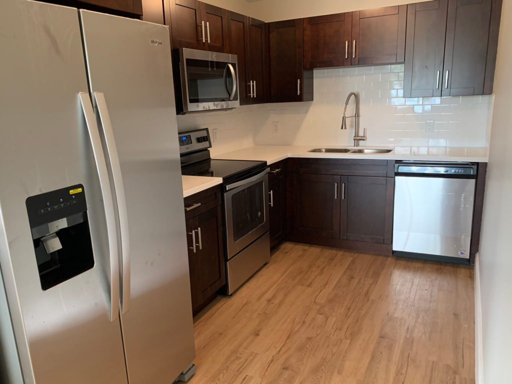 After photo of kitchen with new cabinets, countertop and backsplash