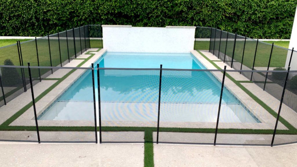 Dipping pool with privacy wall and framed concrete pool deck